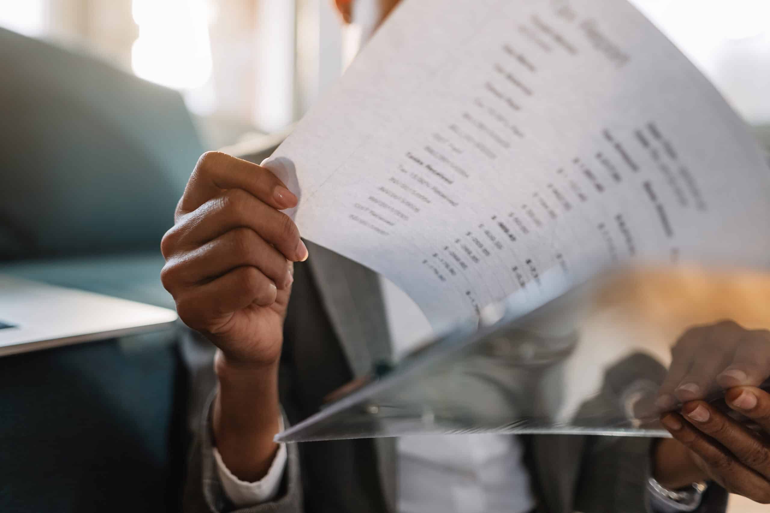 close up of black businesswoman examining reports scaled
