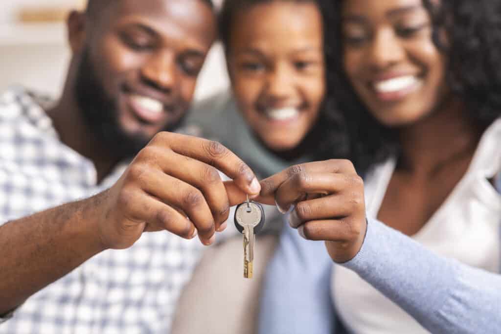 happy african american family holding keys