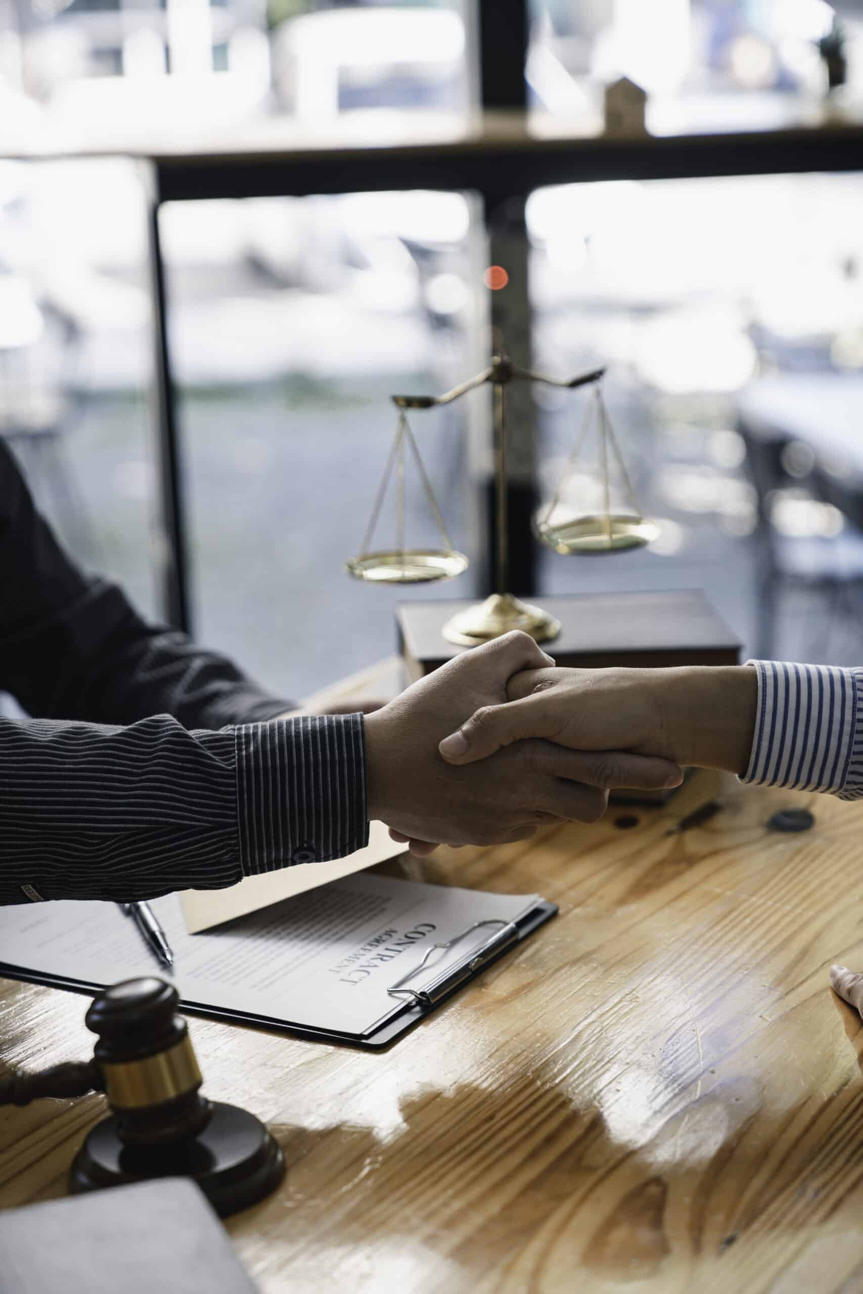 lawyer or judge shaking hands after agreeing scaled