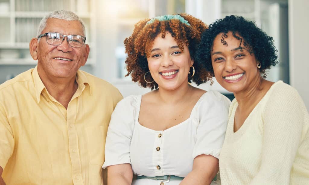 portrait family and grandparents smile in home