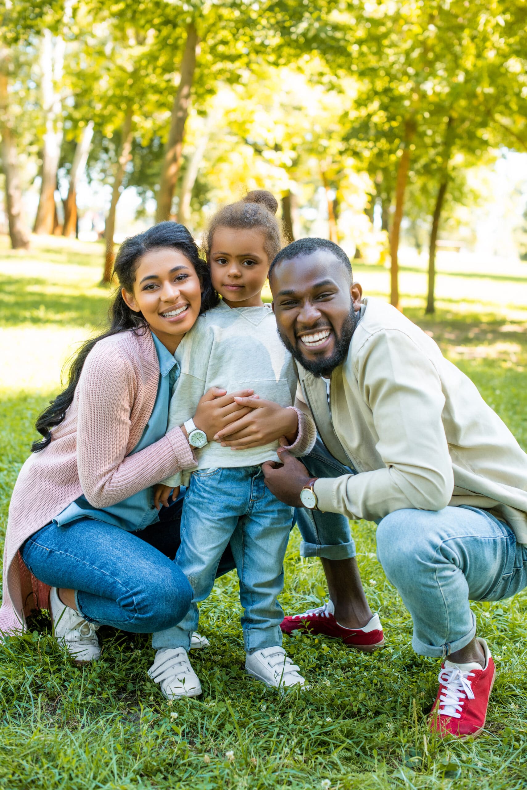 smiling african american parents and daughter scaled