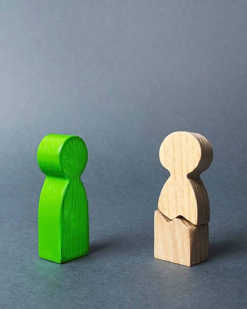 The green person contacts to the cracked figure. Psychological assistance and support, rehabilitation of victims of violence. Overcoming depression. stress. Understanding and compassion.